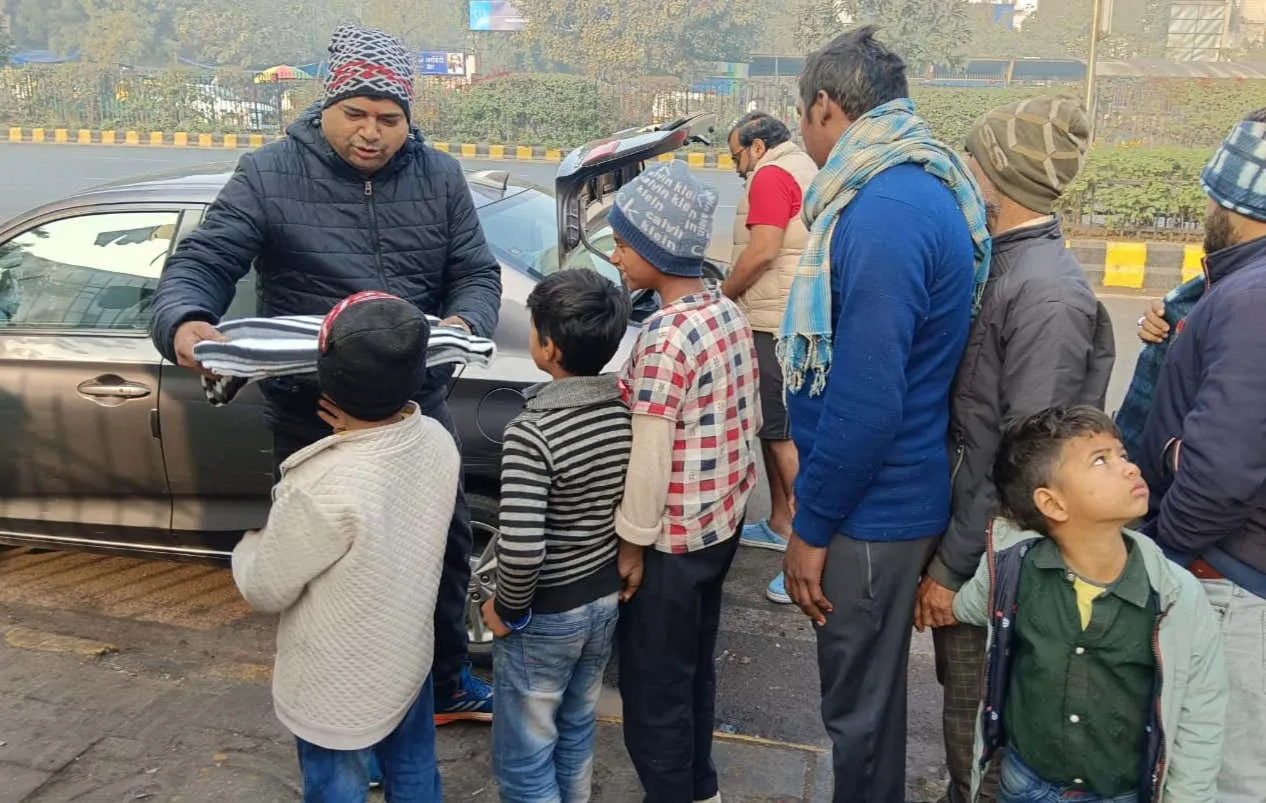 Children receiving warm caps and blankets