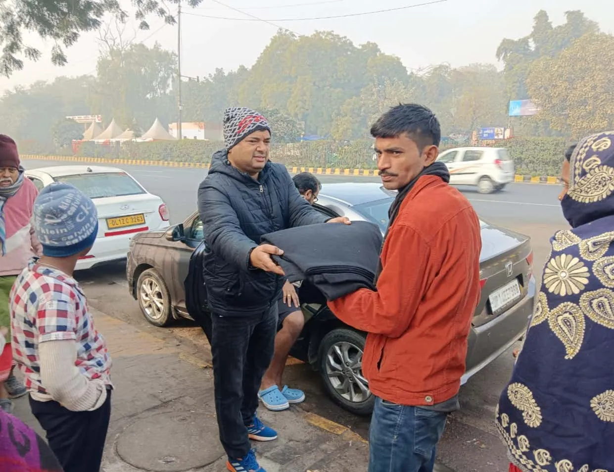 Passing a folded blanket to a young man