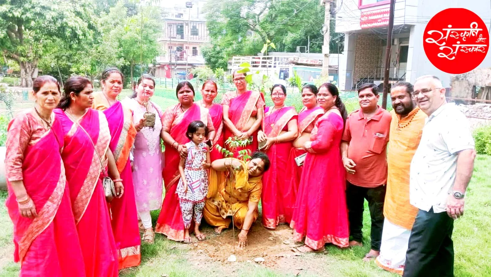 A group portrait around a freshly planted tree