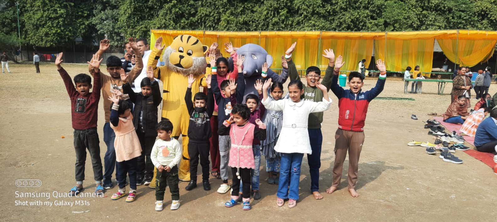 Children celebrate with the event mascots
