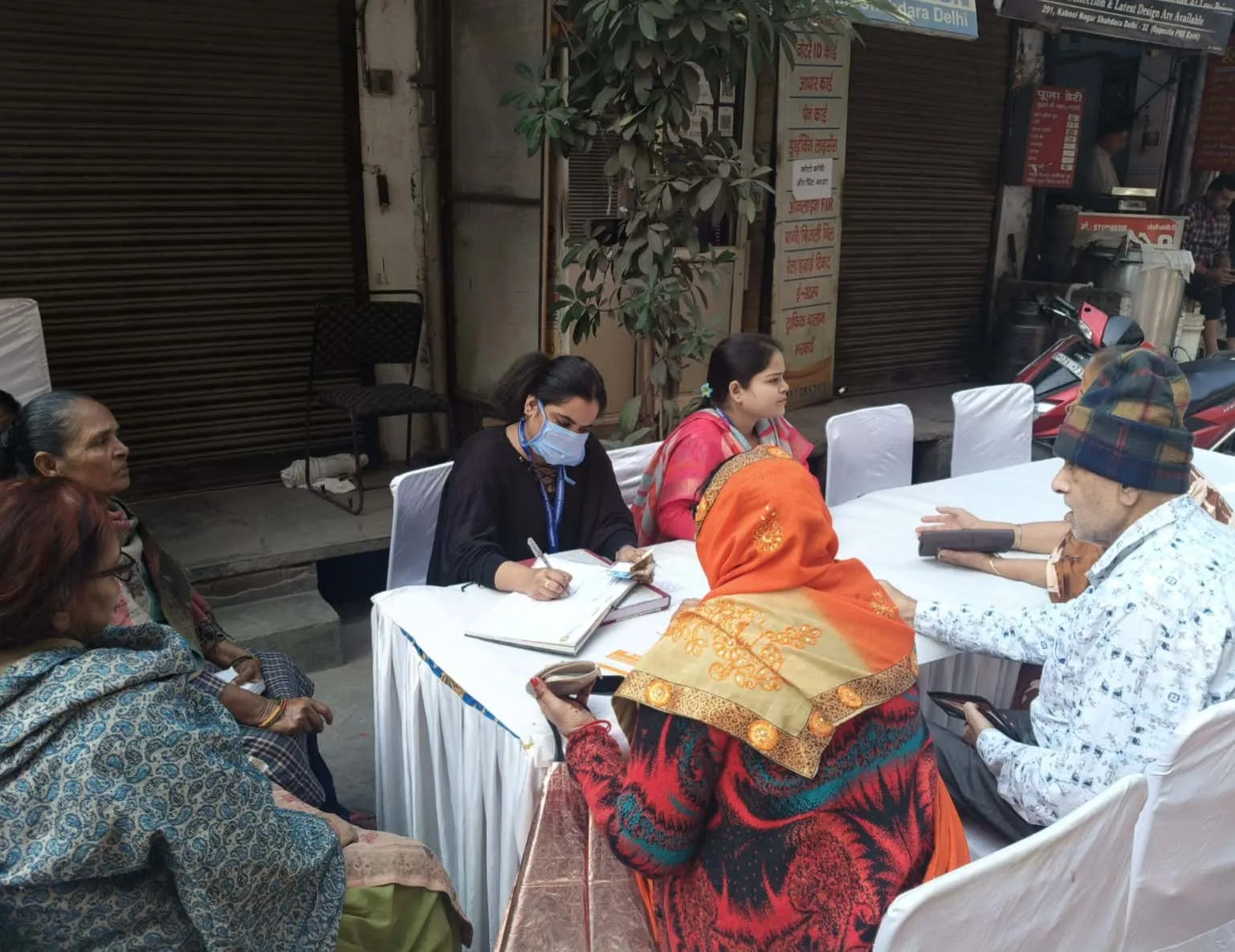 Volunteers registering applicants for welfare schemes